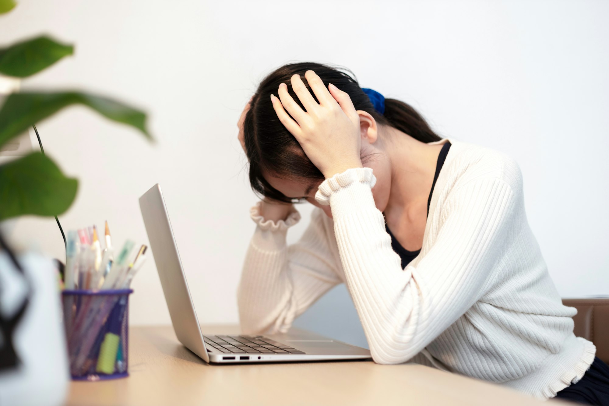 Women are tired and stressed from working hard with laptop. Female depression and anxiety.